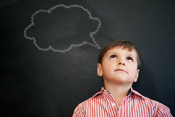 Image showing Boy, standing and blackboard of thought bubble by student as drawing in preschool for imagination. Young child, happy and learning in classroom for education in art for development of creativity