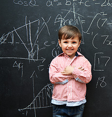 Image showing Child, boy and portrait with math by blackboard with equations, happy and education in classroom at school. Kid, student and numbers for knowledge, learning and chalkboard with smile and preschool