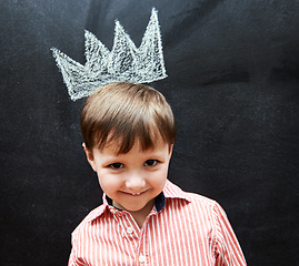 Image showing Little child, portrait and crown on blackboard from mischief of drawing by cute boy in classroom. Young kid, creative and artistic in preschool for elementary education, youth and clever student