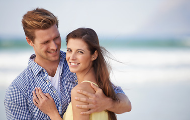 Image showing Portrait, couple and smile for embrace, beach and romantic date on sunny afternoon in Spain. Hug, man and woman in love for kind relationship, fun dating and bonding together on weekend getaway