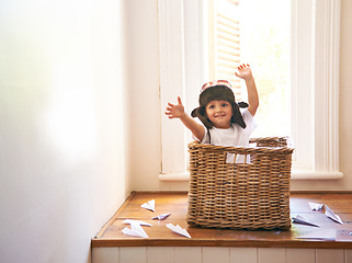 Image showing Flying, paper plane and child playing with adventure, imagination and fun in basket at home. Fantasy, little pilot and playful boy in box with future dream, growth and development with airplane