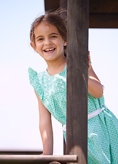 Image showing Portrait, smile and child at playground outdoor in summer for fun on vacation with cute, adorable and innocent girl. Playing, happy and kid at jungle gym, funny and laughing for joy alone in Spain