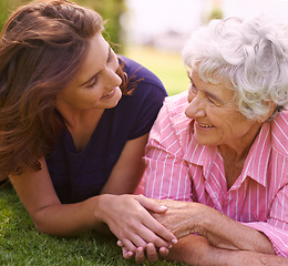 Image showing Senior, mother and woman holding hands outdoor to relax in garden in summer, holiday or vacation together. Elderly, mom and family with love, care and support and smile in retirement with wellness