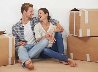 Image showing New property, boxes and happy couple for moving with mortgage and excited for investment in real estate. Man, woman and proud homeowner with love hug in home and funny joke in house in living room