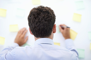 Image showing Businessman, writing and sticky notes on wall for planning, brainstorming and project reminder with rear view. Entrepreneur, employee and ideas for agenda, schedule and proposal information at work