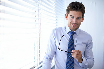 Image showing Businessman, portrait and smile for office, glasses and in professional workspace. Male person, smart and confident for ambition, startup and entrepreneur for career and corporate project expert