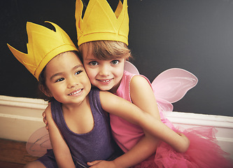 Image showing Children, cute and costumes in portrait with hug for friendship, smile and dress up in fairy clothes for fun. Girls, play and love for diversity, happiness and princess with wings for embracing