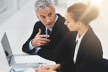 Image showing Boss, laptop and meeting with employee in office with brainstorming in corporate company. Woman, serious and listening to CEO of business, professional and notebook for planning on desk in workplace