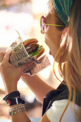 Image showing Face, fast food and woman eating burger closeup outdoor for hunger, takeaway or craving in summer. Hamburger, lunch or snack with head of hungry young person biting a beef bun for cuisine or meal