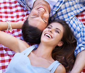 Image showing Relax, love and happy with couple and picnic in park for romance, valentines day and date together. Smile, calm and vacation with man and woman laughing on blanket for summer, bonding and peace