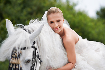 Image showing Bride, woman and riding with horse or portrait outdoor with happiness for celebration, marriage and confidence. Wedding, person and stallion on lawn in field with smile, dress and animal at ceremony