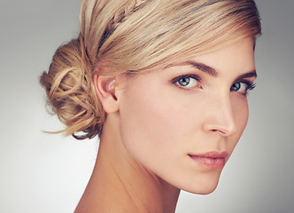 Image showing Portrait, young woman and beauty face with skin glow of model. Female person, natural and with makeup, cosmetics and blonde hair against grey background with haircare and skincare for natural shine