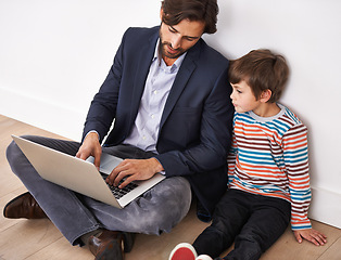 Image showing Father, son and bonding on floor with laptop for remote work with video streaming, online games and movies in home. Family, parent and child with technology on ground for relax, communication and fun