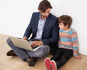 Image showing Father, son and relax in home with laptop for remote work with video streaming, online games and movies on floor. Family, parent and child with technology on ground for bonding, communication and fun