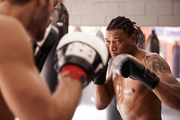 Image showing Men, coach and martial arts with combat training in fight, gloves and partner for punch at gym. People, challenge and action for mma, boxing and hands with power, workout and exercise for competition