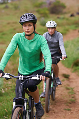 Image showing Woman, friends and cycling in nature on bicycle for fitness, cycling or off road travel on trail or path. Female person, biker or cyclist in forest for outdoor workout, training or sports exercise