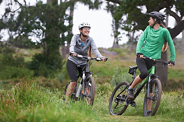 Image showing Happy woman, friends and fitness with bicycle on field for outdoor cycling, workout or cardio exercise in nature. Female person, athlete or cyclist with smile in forest for off road training on trail