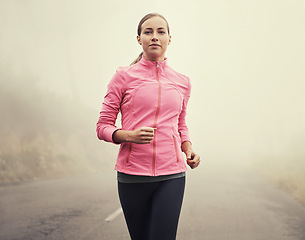 Image showing Nature, fitness and portrait of woman running on mountain road for race, marathon or competition training. Sports, exercise and female athlete with cardio workout in misty outdoor woods or forest.