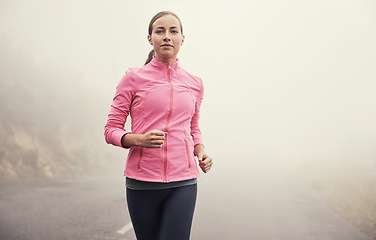 Image showing Nature, sports and portrait of woman running on mountain road for race, marathon or competition training. Fitness, exercise and female athlete with cardio workout in misty outdoor woods or forest.