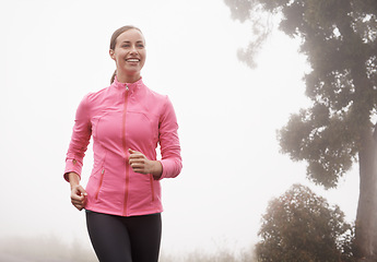 Image showing Nature, fitness and young woman athlete running on mountain road for race, marathon or competition training. Sports, exercise and female person with cardio workout in misty outdoor woods or forest.