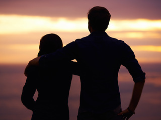 Image showing Back, sunset and couple hug with silhouette, view outdoor with nature and travel together for love and bonding. Adventure, journey and people in environment, orange sky with support and trust