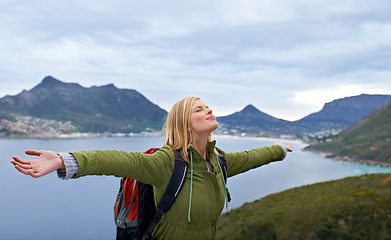 Image showing Woman, hiking and freedom on mountains for travel, success and achievement or fresh air in Europe. Young person with backpack, breathing and stretching arms for trekking, journey or outdoor adventure