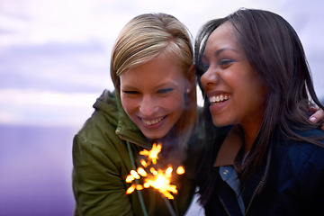 Image showing Women, friends and happy with sparklers outdoor, celebration and fun with hiking or travel in nature. Friendship, bonding and sparks with horizon, smile for adventure together and evening sky
