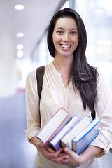 Image showing Woman, portrait and smile with books in hallway for learning, scholarship and studying at university. College, student and person with face, happy and backpack for education, research and knowledge