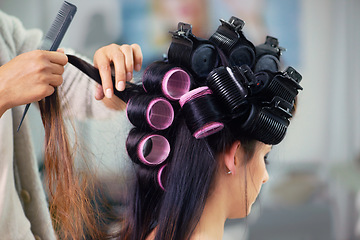 Image showing Woman, hair care and makeup with curlers and hands of stylist, cosmetic care and beautician with treatment. Beauty in salon, actor or celebrity backstage with hairdresser and styling for glamour