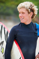 Image showing Man, surfer and face or happy outdoor with surfboard for adventure, vacation or holiday. Surfing, person and smile with travel in nature for exercise, water sports or swimming in summer with wetsuit