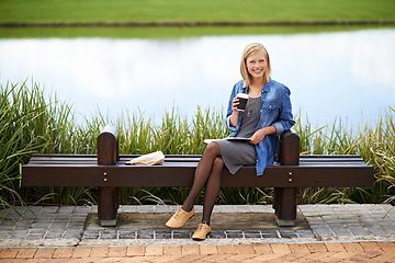 Image showing Coffee, park and portrait of woman on bench with newspaper for lunch break, relax and calm in nature. Happy, reading and person outdoors with caffeine drink, beverage and tea by lake on weekend