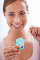 Image showing Portrait, smile and dental floss for oral hygiene care with woman in bathroom of home for teeth whitening. Face, product and happy young person in apartment to prevent tooth decay or gum disease