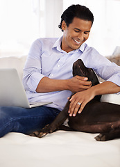 Image showing Man, dog and face with laptop on couch for bonding, playing or happiness with remote work in home. Animal, person and cuddle with smile on sofa in living room for research, comfort and love for puppy