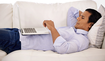 Image showing Remote work, laptop and businessman relax on sofa streaming, video or social media at home. Pc, search or freelancer in living room watching online tutorial for elearning, upskill or training course