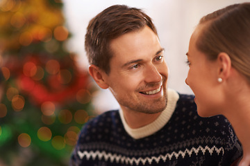 Image showing Happy, conversation and couple on a date on Christmas for romantic, holidays and love bonding. Smile, care and young man and woman talking in living room with xmas festive decoration at home.