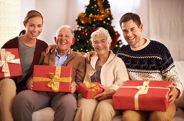 Image showing Grandparents, family with Christmas or portrait for festive season together for celebration, presents or holiday. Elderly man, woman and couch at home in Canada for bonding joy, vacation or relaxing