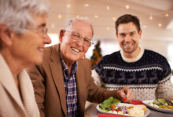 Image showing Grandfather, portrait and family at dinner on Christmas together with food and celebration in home. Happy, event and old man smile with plate at lunch and relax on holiday at table with people