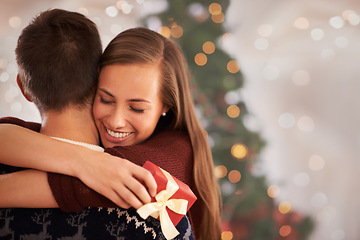 Image showing Home, hug and couple with love, Christmas and festive season with marriage and holiday. Apartment, embrace or man with woman or vacation with Xmas or celebration with relationship or bonding together