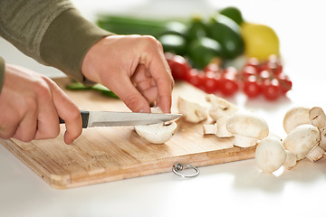 Image showing Diet, cooking and hands cutting mushroom on kitchen counter with salad, wellness and nutrition in home. Board, knife and healthy food with vegetables at brunch, chef and vegan meal prep in apartment