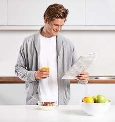 Image showing Breakfast, juice and man with newspaper in kitchen for information at modern apartment. Nutrition, cereal and young male person drinking healthy beverage and reading public journalism at home.