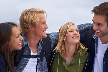 Image showing Friends, group and happy for hiking, adventure and travel together in conversation, hug and love outdoor. Excited and young people with backpack and laughing for funny discussion, trekking or journey