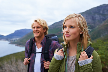 Image showing Happy couple, hiking and backpack on mountain for sightseeing, travel or outdoor journey in nature. Face of young man, woman or hikers carrying bag on back for trekking, fitness or adventure in woods