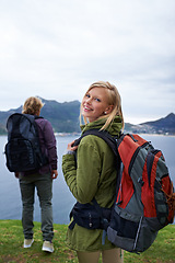 Image showing Happy couple, portrait and hiking with backpack for adventure, travel or outdoor journey together in nature. Young man and woman with smile and bag for trekking, explore or fitness by the ocean coast