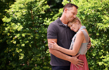 Image showing Love, hug and couple in nature with support, commitment and trust, care and solidarity while bonding in a park. Safety, security and people embrace in a garden with peace, calm or soulmate connection