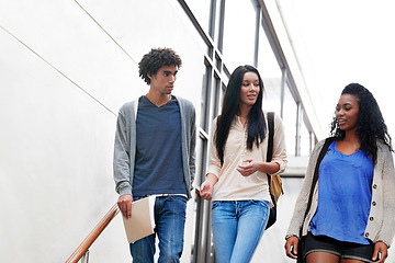 Image showing University, friends and group of students walking on stairs talking, speaking and in conversation on campus. Education, college and women and men chat for academy, learning and studying together