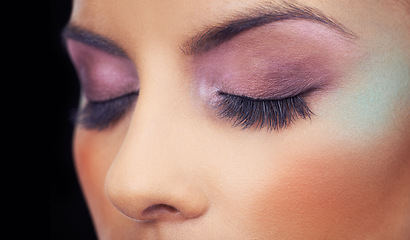 Image showing Eyes, makeup and woman with colorful and creative beauty in studio and black background. Unique, cosmetics and model with bold eyeshadow aesthetic on face to glow or shine with confidence in identity