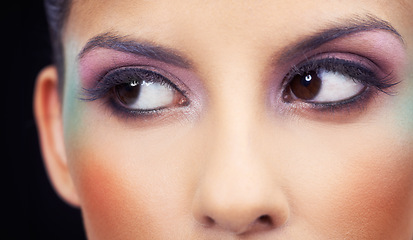 Image showing Eyes, makeup and woman with colorful and creative beauty in studio and black background. Unique, cosmetics and model thinking with rainbow aesthetic on face to glow or shine with bold confidence