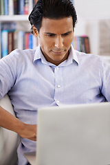 Image showing Businessman, laptop and reading on sofa in home for remote work, research and online planning in living room. Entrepreneur, person and technology with corporate project, communication and web surfing