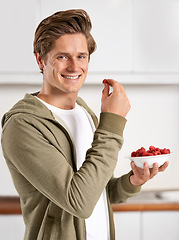 Image showing Smile, portrait and man with raspberries in kitchen of home for diet, health and wellness. Happy, confident and male person eating fruit for fresh, organic or nutrition snack in modern apartment.