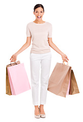 Image showing Woman, portrait and shopping bags or excited in studio as customer or discount, promotion or giveaway. Female person, face and fashion product on white background for purchase, retail or mockup space